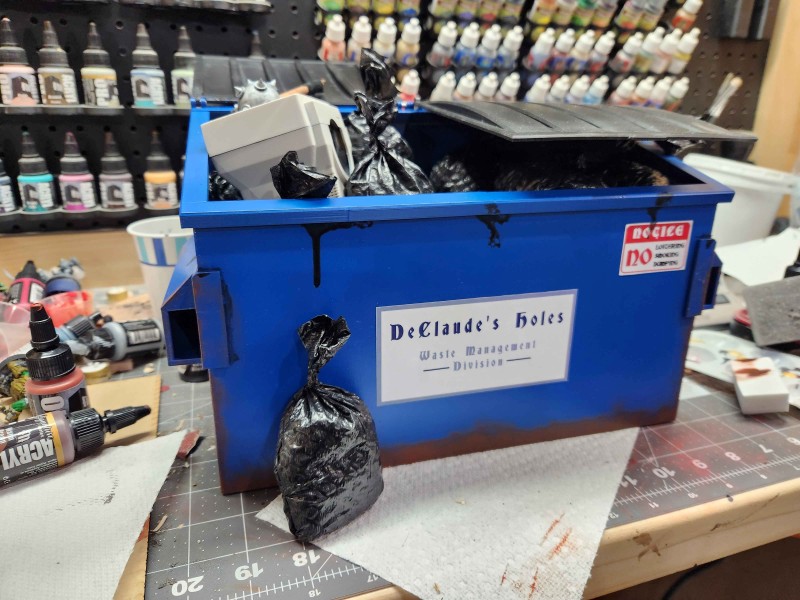 Dumpster with some trash bags and initial weathering.